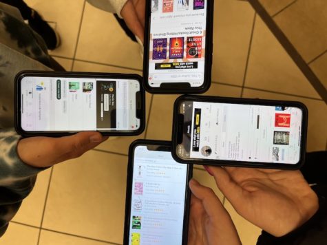 Four students comparing their profiles and statistics on the app. Many enjoy talking about the app during their breaks.