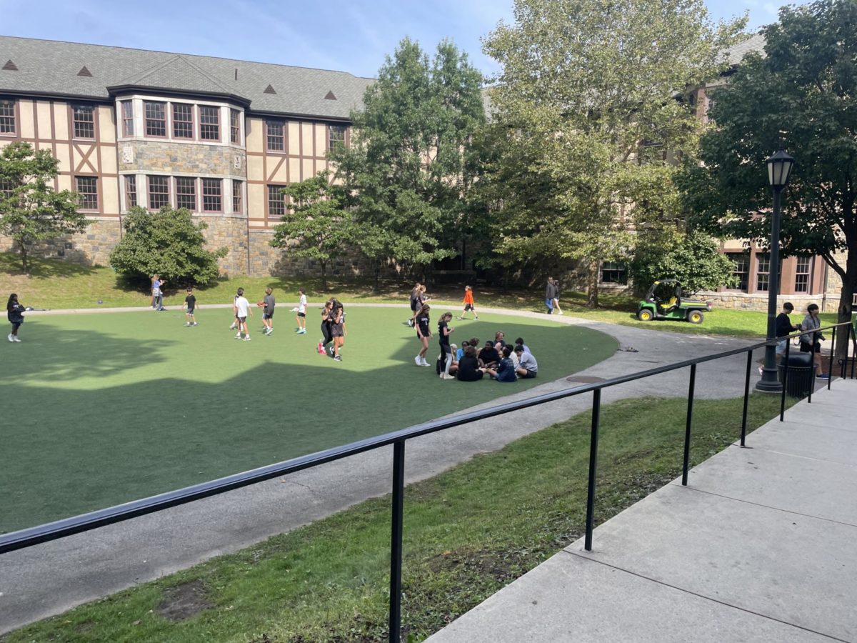 Students converse on Akin common. Many students spend their recess on Akin common. Many soccer and football games are played on the common by students during lunch.
