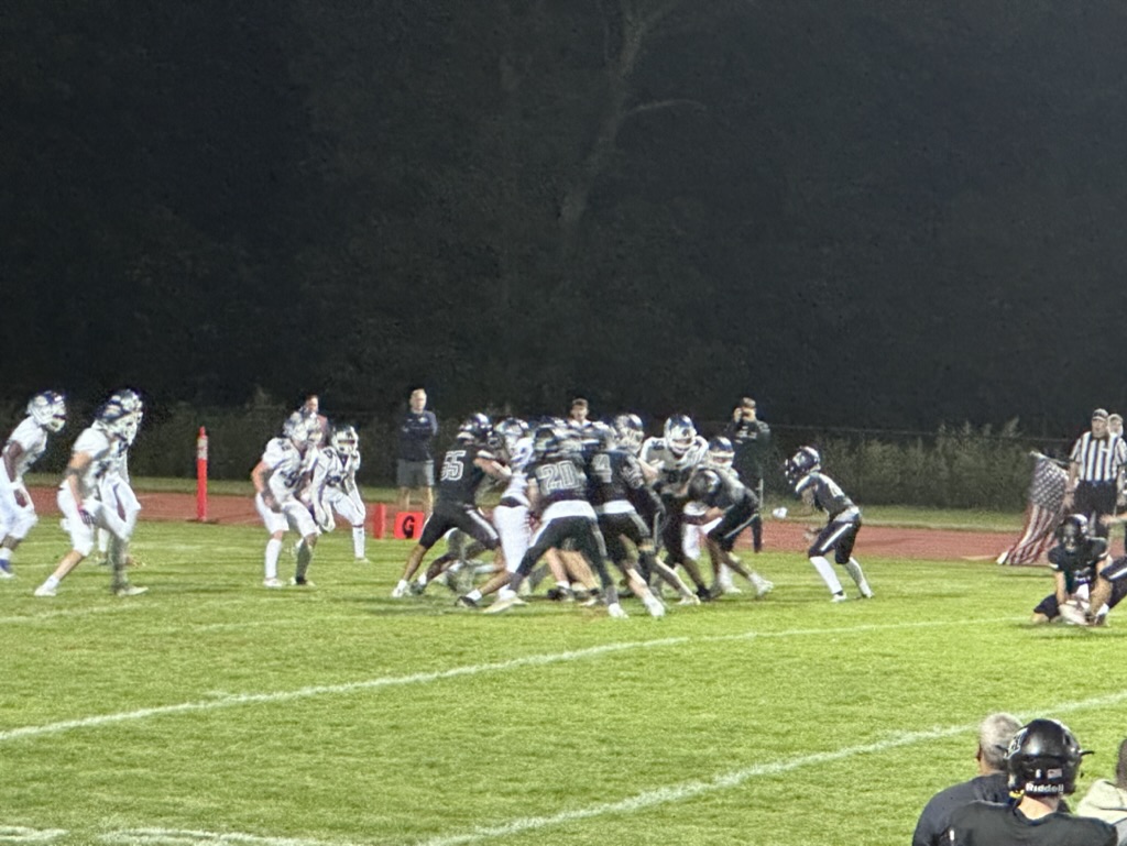 Football players in a huddle trying to get the ball. Hackley did an amazing job during this game. 