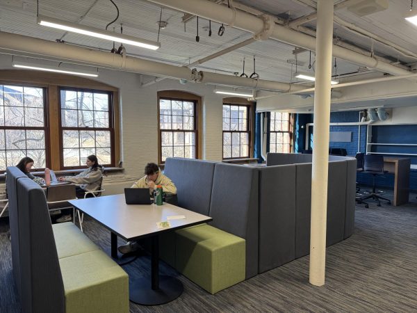 Students working hard in the student lounge during their free period. The windows offer a nice natural light to the room.