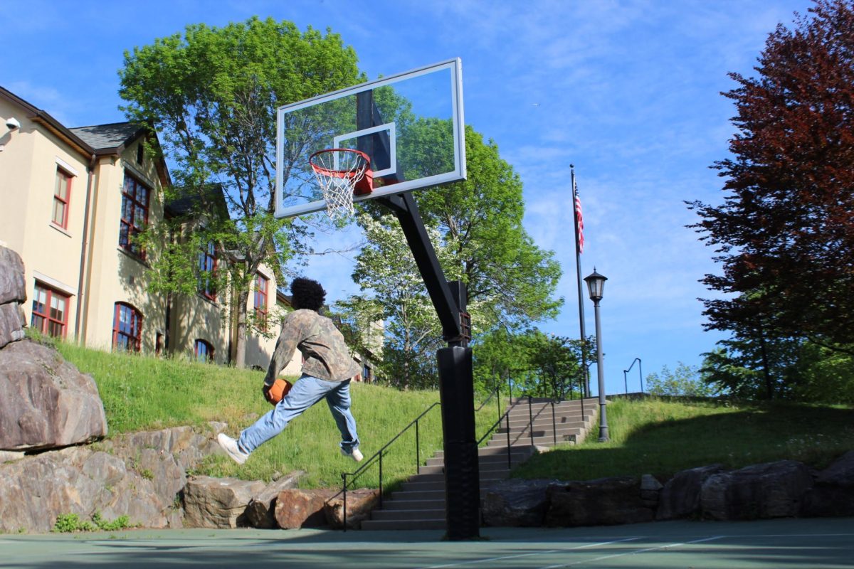 Sophomore Brandon Acosta is practicing his basketball skills on the middle school basketball court. He is working on his layup. Brandon makes a flagrant jump into the air before perfectly swishing the ball into the hoop.
"I like basketball," Brandon says.