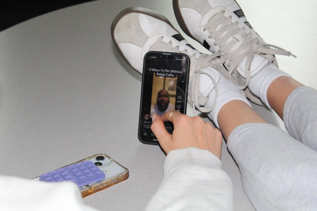 Two freshmen watch videos on Instagram Reels in the new student lounge. They are very comfortable because of the great seating arrangement. Students use the lounge to study and hang out.
