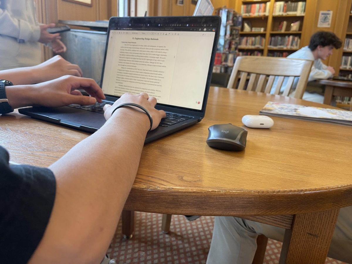 Ninth grader Patrick Flores is hard at work while hanging out with his friends. Patrick spends his free period working on a history assignment due the next day.