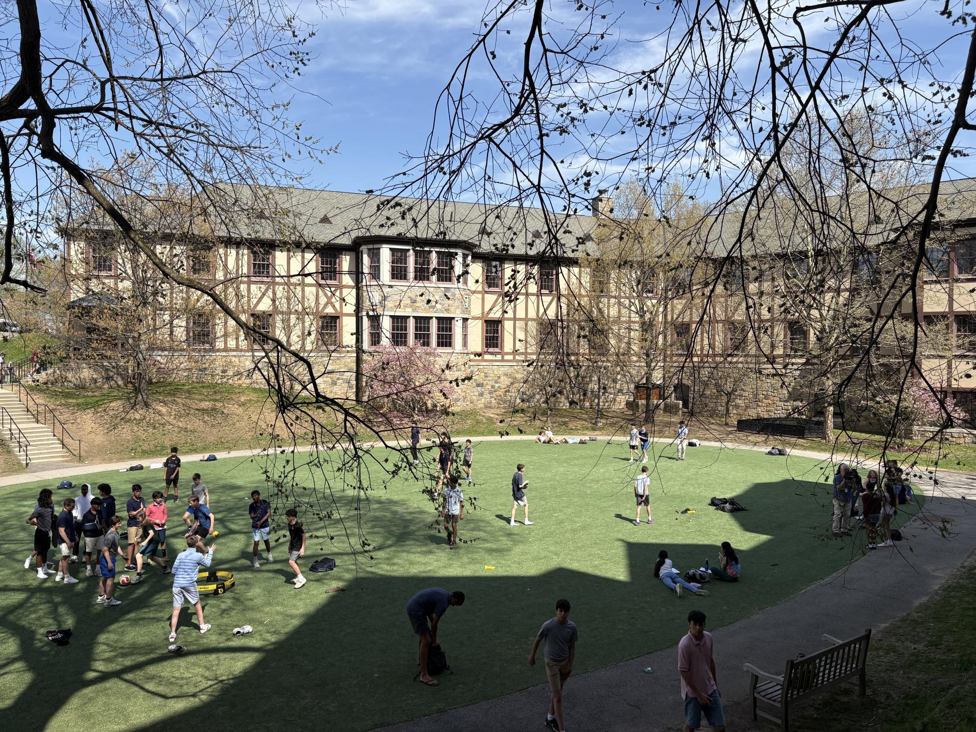 This photo shows the popularity of Akin Common for the student body during with many students either playing sports or relaxing on the turf fields.